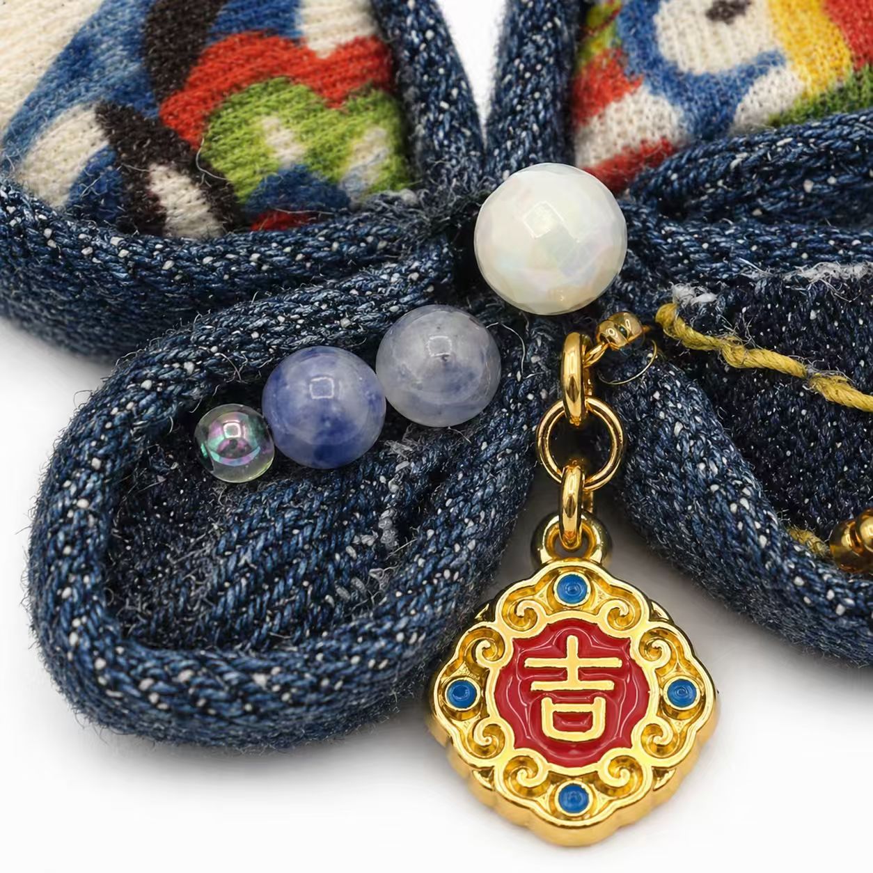 Detail of beads and charm on the brooch